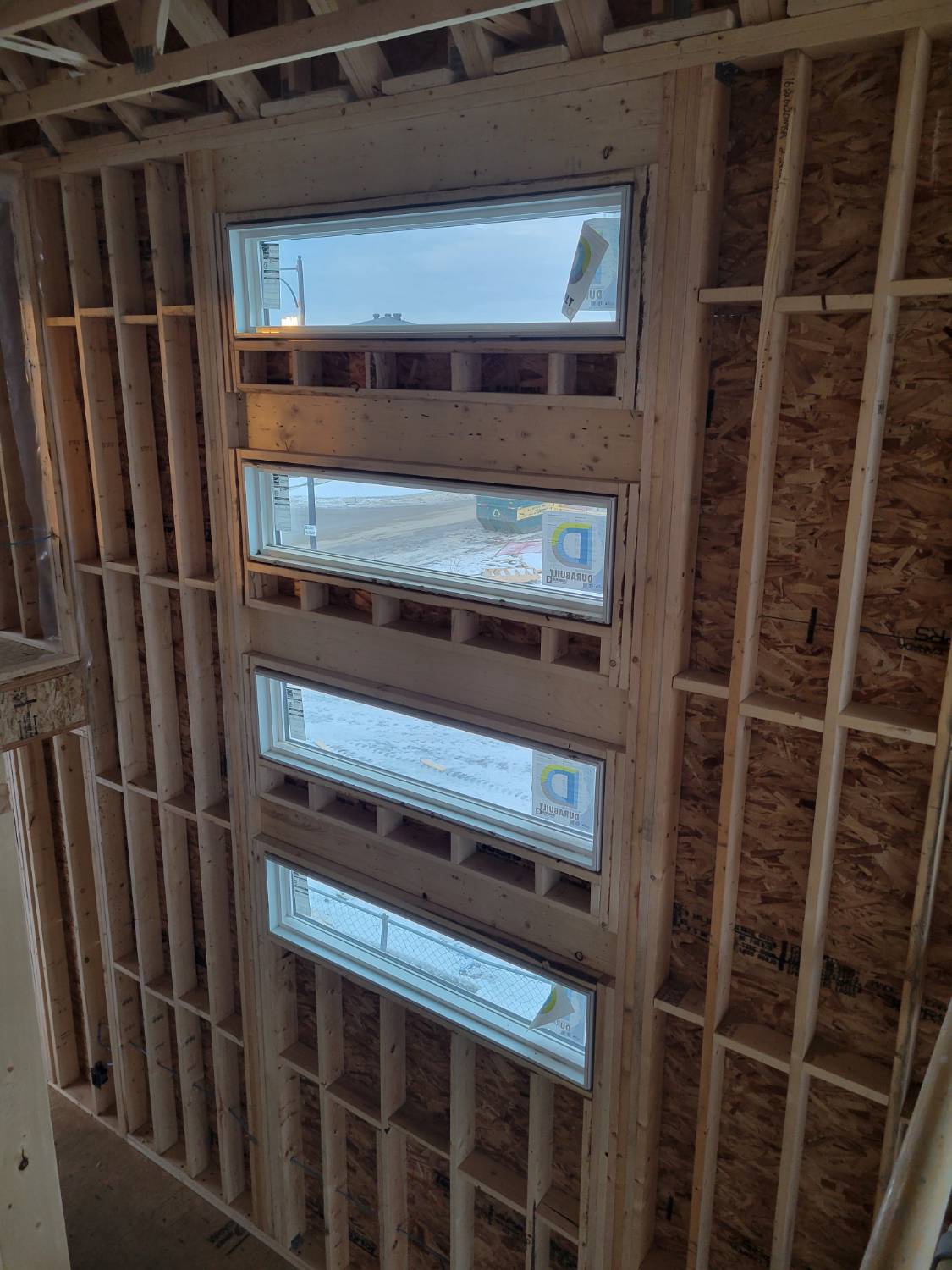 Tall Wall framing showing a stacked window configuration on a new build home. 