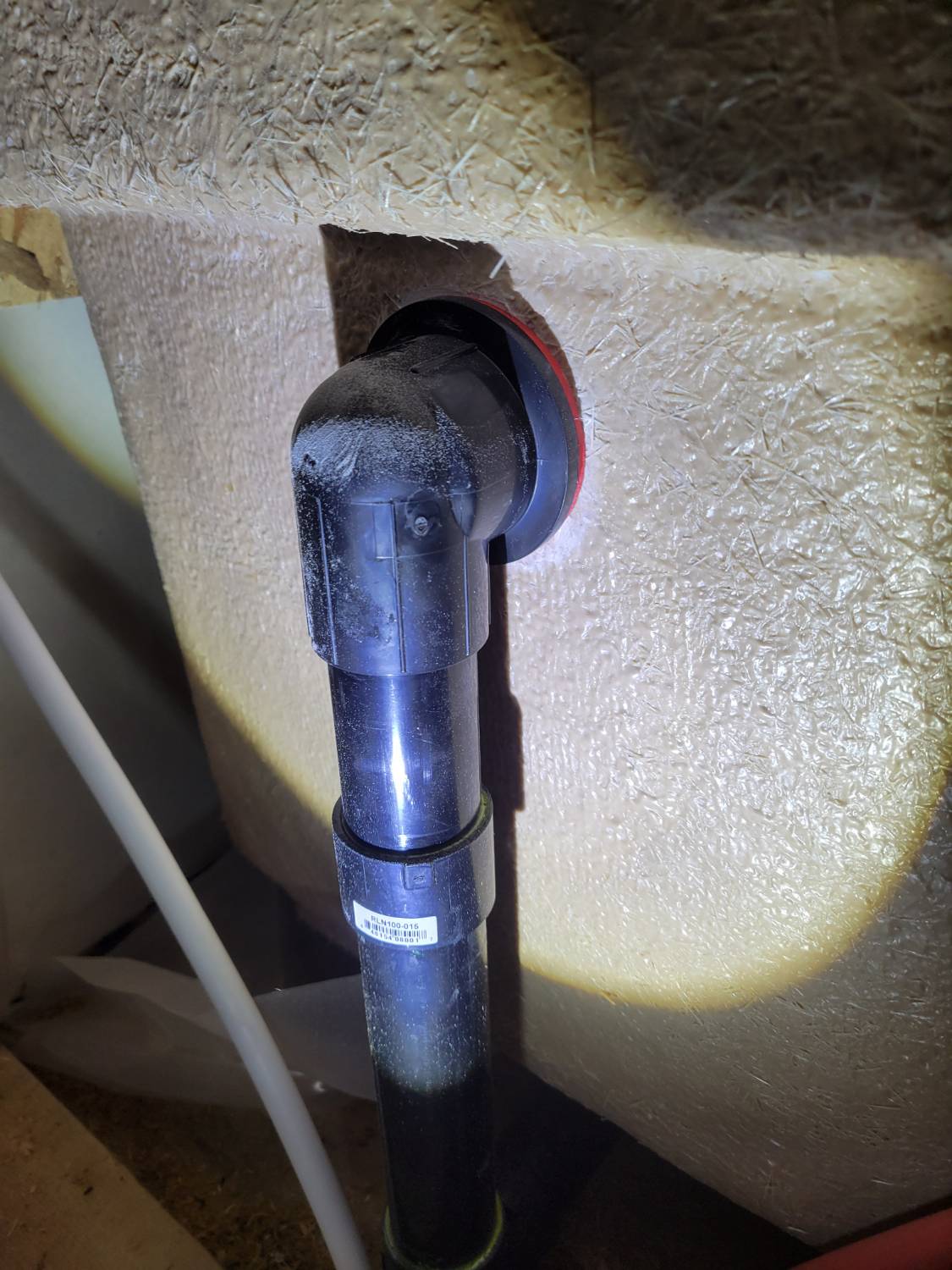 The overflow connection on the tub being inspected during a new build home inspection prior to the walls being concealed.