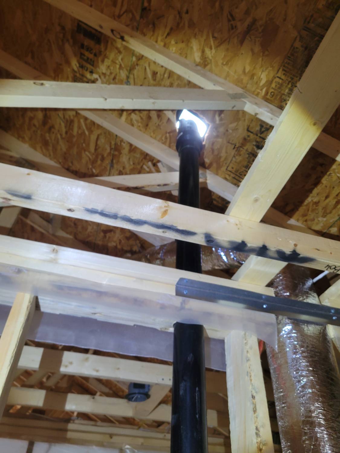 A view of the attic showing the roof has not yet been sealed during a new build home inspection.