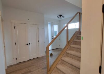 New home staircase and hallway showing pre delivery inspection tape identifying minor finishing defects.