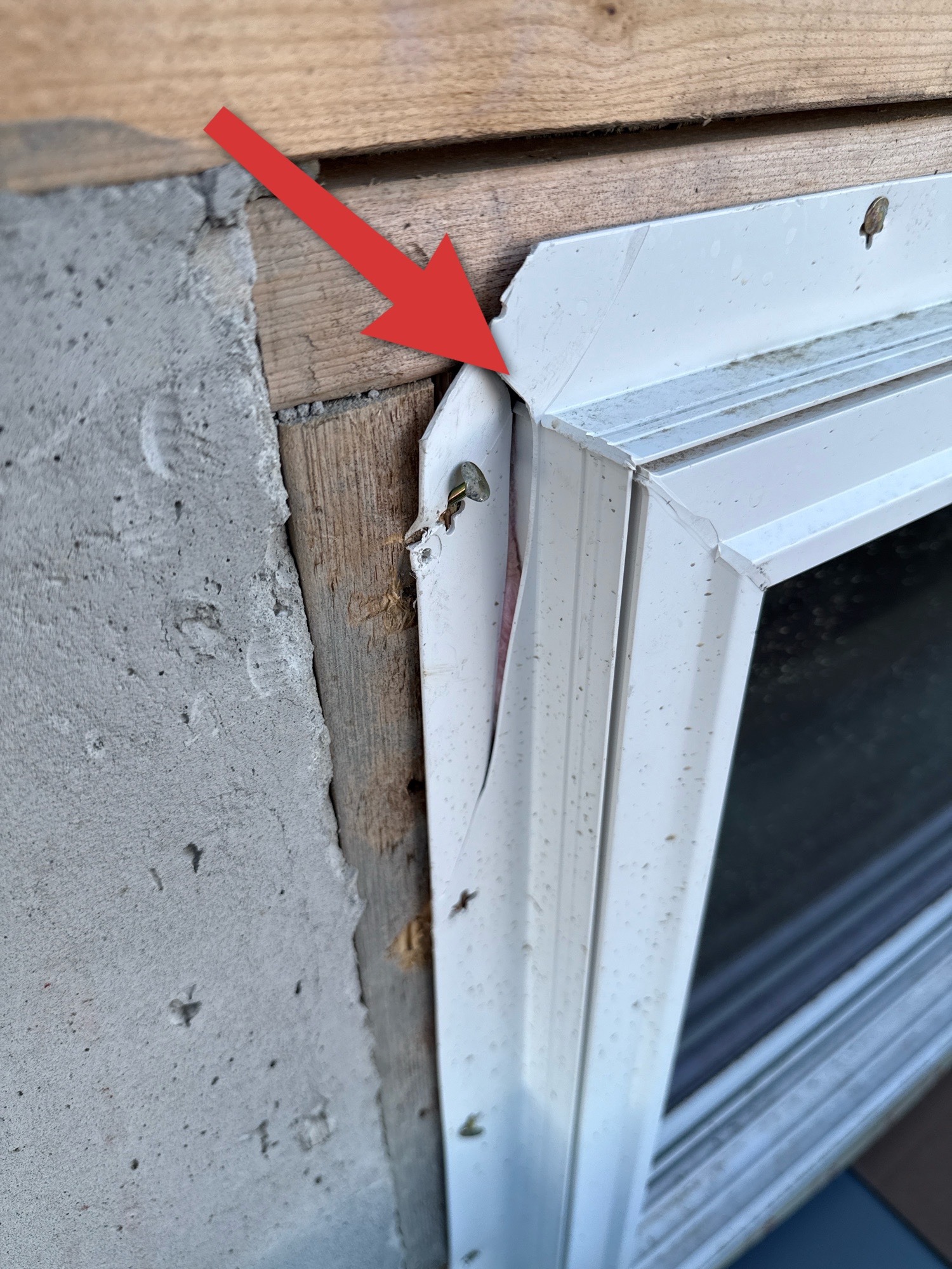 Damaged window flange on a new home, showing gap at frame during inspection.